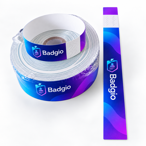 Roll of PP wristband material beside a printed strip with tear tab