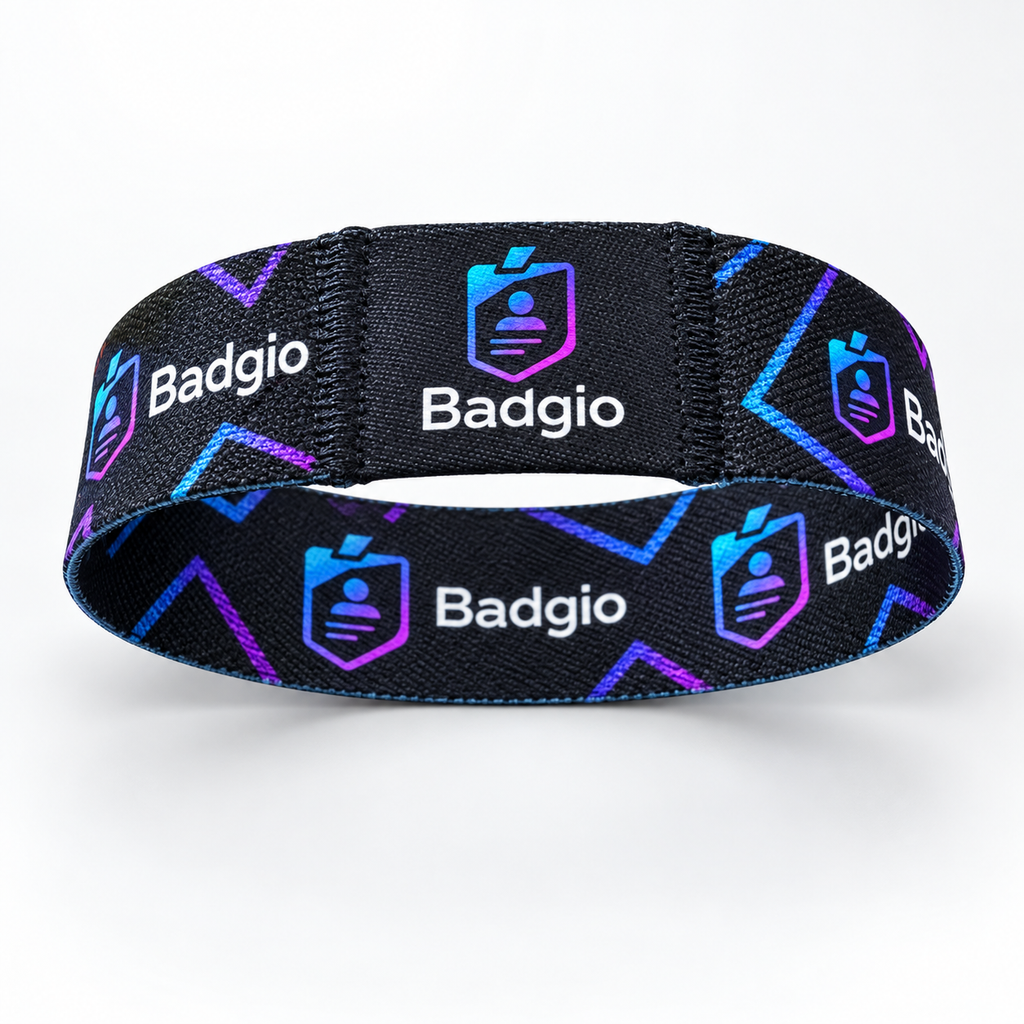 Black fabric RFID event wristband with repeating Badgio logo pattern