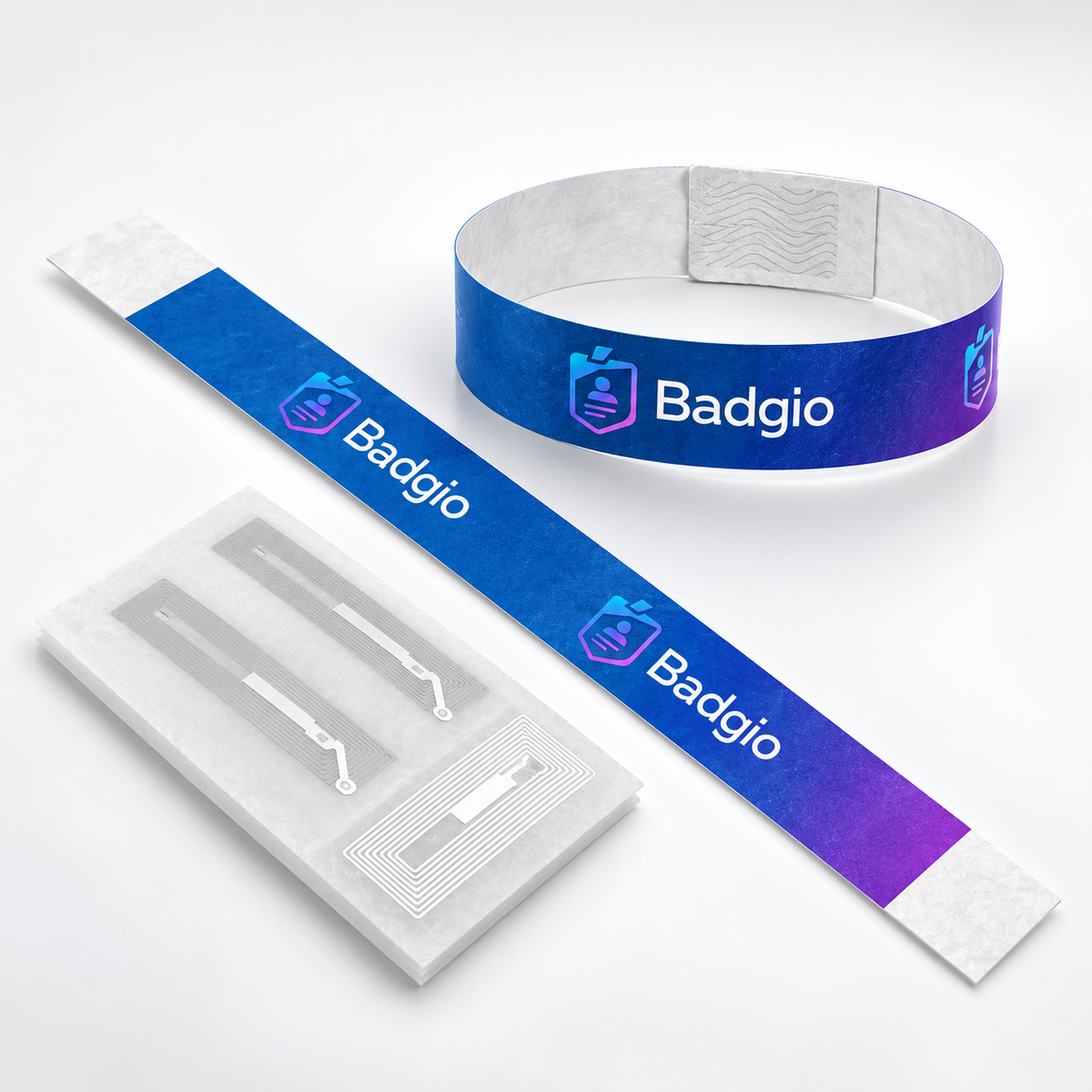 UHF RFID Tyvek wristband strip and formed band beside long-range antenna inlays